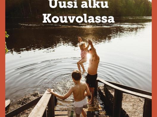 A man and two children stepping to water on sunny summer day. 