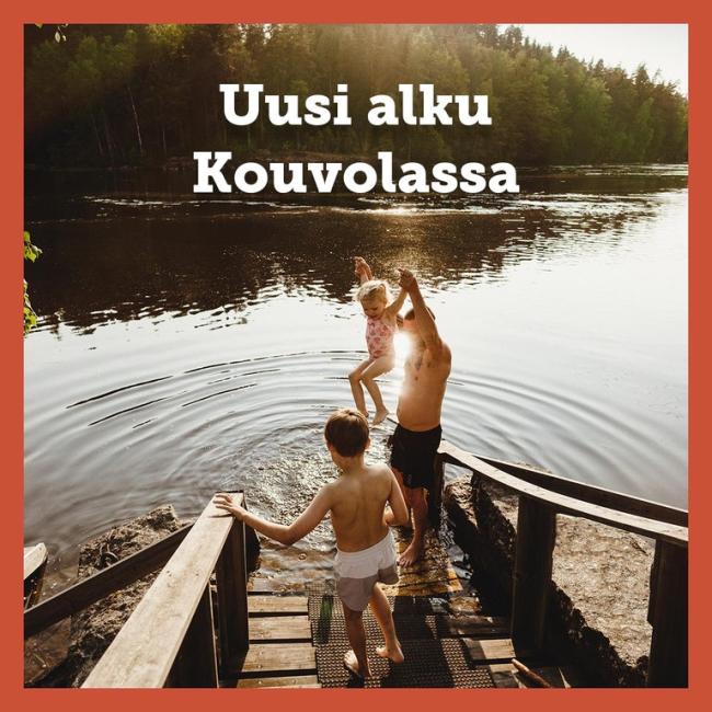 A man and two children stepping to water on sunny summer day. 